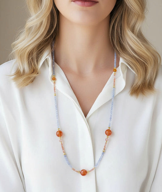 Person wearing a long beaded necklace with 'Amy's Garden' branding.