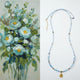 Collage of a floral painting on the left and a blue beaded necklace with a pendant on the right.