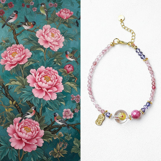 Bracelet with pink beads and charms on a white background, next to floral and bird wallpaper.