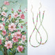 Two necklaces with floral patterns on a white background
