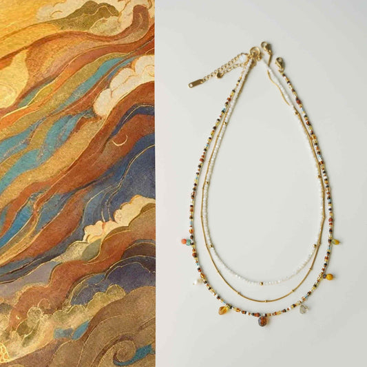 Necklace with beaded details on a light gray background