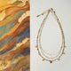Necklace with beaded details on a light gray background