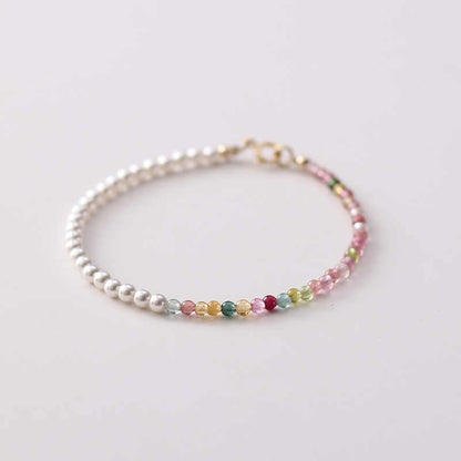 A bracelet with multicolor tourmaline and white pearl beads, featuring a gold-plated clasp.