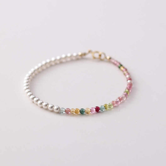 A bracelet with multicolor tourmaline and white pearl beads, featuring a gold-plated clasp.