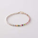 A bracelet with multicolor tourmaline and white pearl beads, featuring a gold-plated clasp.
