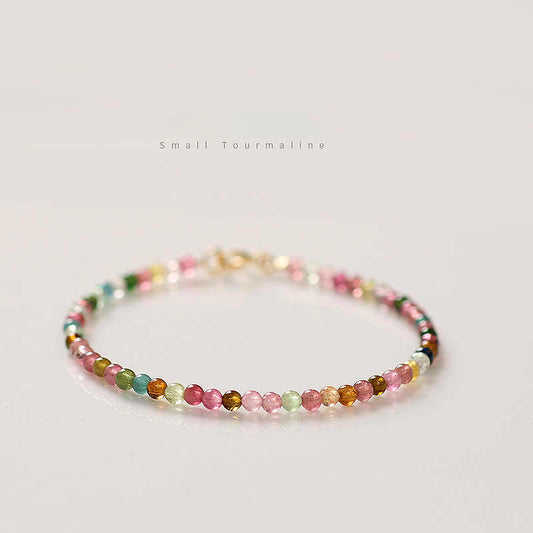 Multicolored beaded bracelet on a light gray background