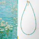 Necklace with blue beads and gold accents next to a painting of water lilies