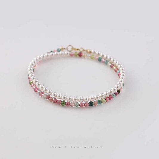 Beaded bracelet with multicolored beads and pearls on a white background