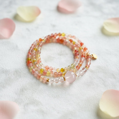 Stack of multicolored beaded bracelets on a light background