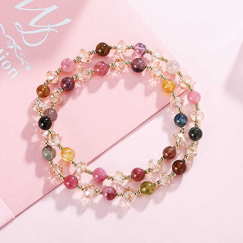 Multicolored beaded necklace on a pink background