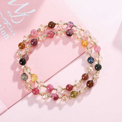 Multicolored beaded necklace on a pink background