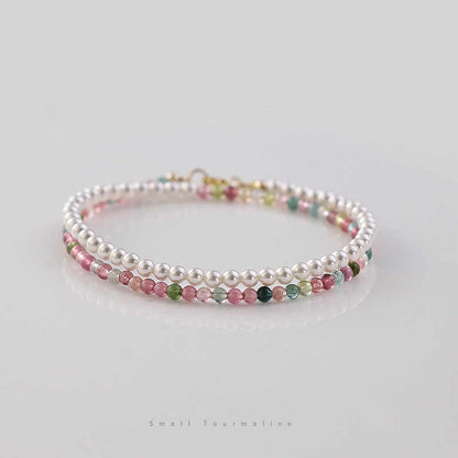Beaded bracelets with pink, green, and white beads on a light background