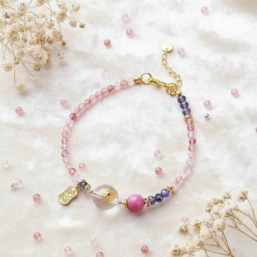 Bracelet with pink and purple beads on a white background