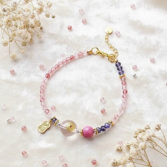 Bracelet with pink and purple beads on a white background