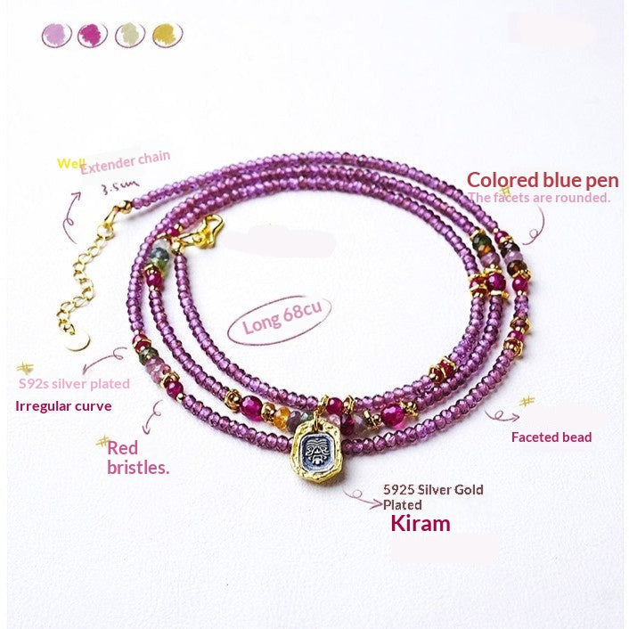 Pink beaded bracelet with gold accents on a white background
