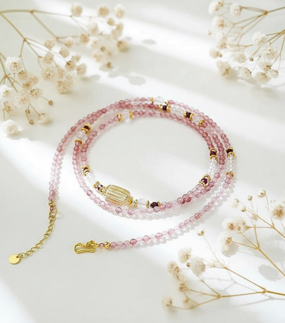 Pink beaded bracelet with gold accents on a light background with dried flowers