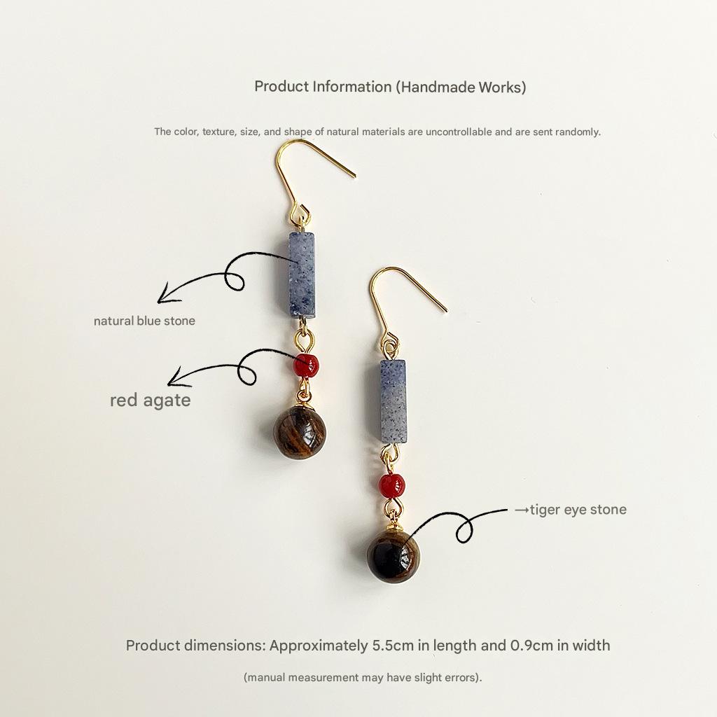 Pair of earrings with natural blue stone, red agate, and tiger eye stones on a white background.
