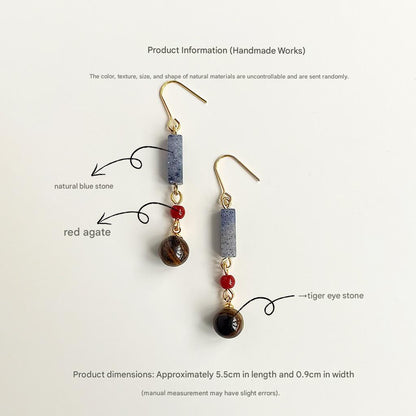 Pair of earrings with natural blue stone, red agate, and tiger eye stones on a white background.