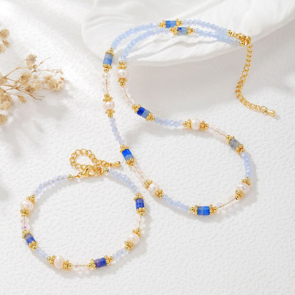 Necklace with blue and gold beads on a white background