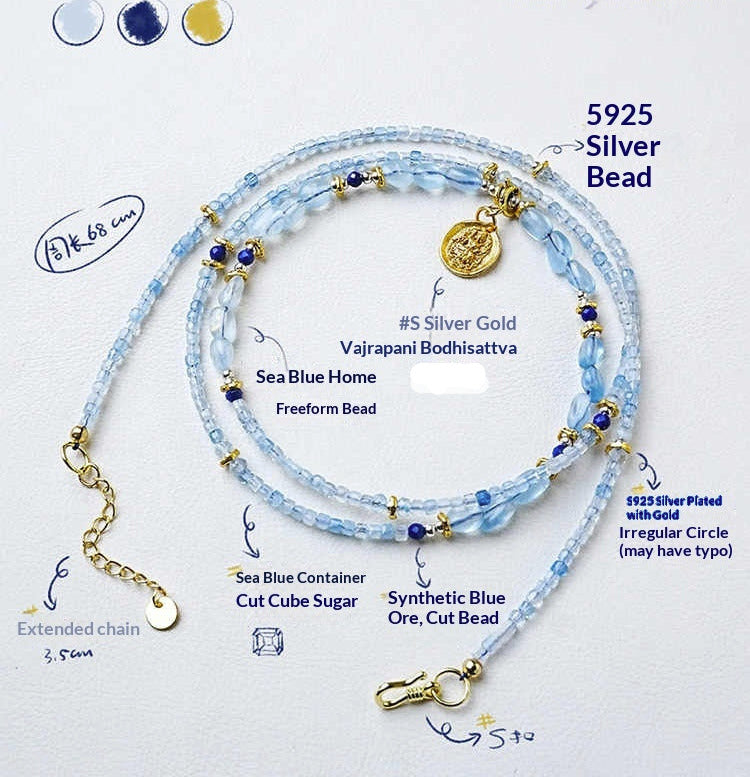 Necklace with blue beads and gold accents on a white background