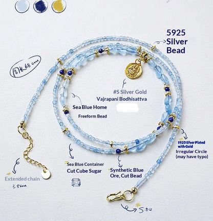 Necklace with blue beads and gold accents on a white background