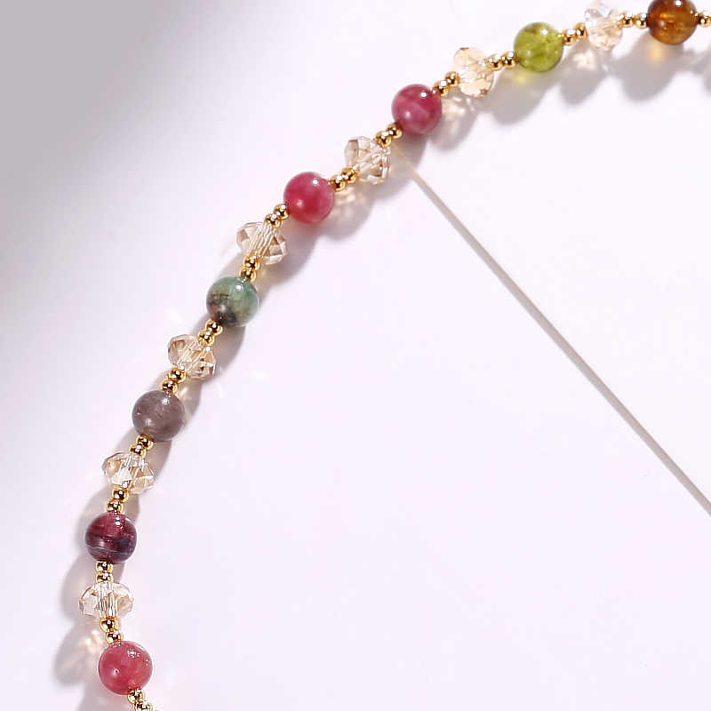 Close-up of a beaded headband with multicolored beads on a white background