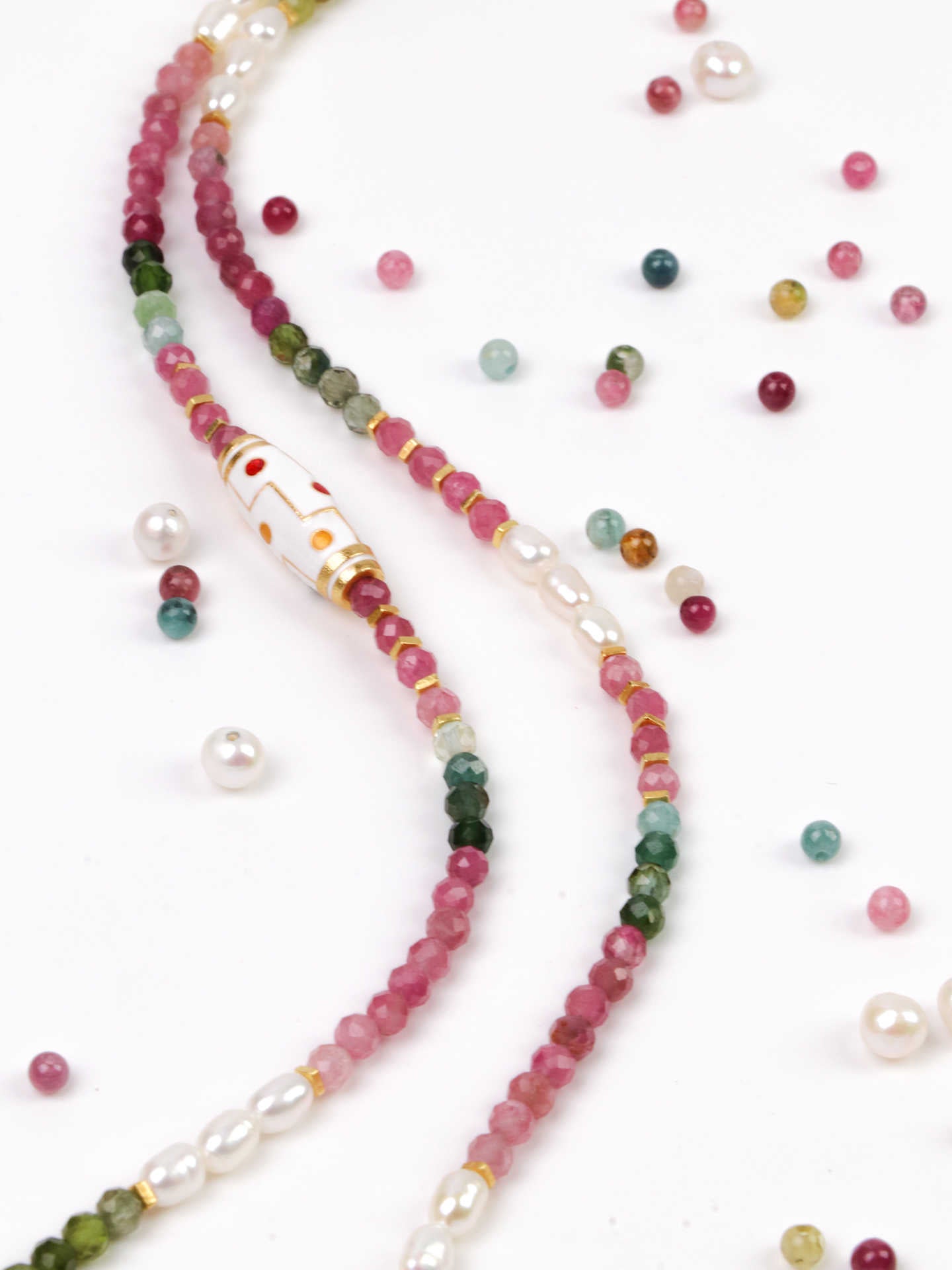 Beaded necklace with multicolored beads on a white background