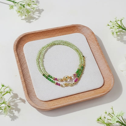 Jewelry set on a wooden tray with white flowers around