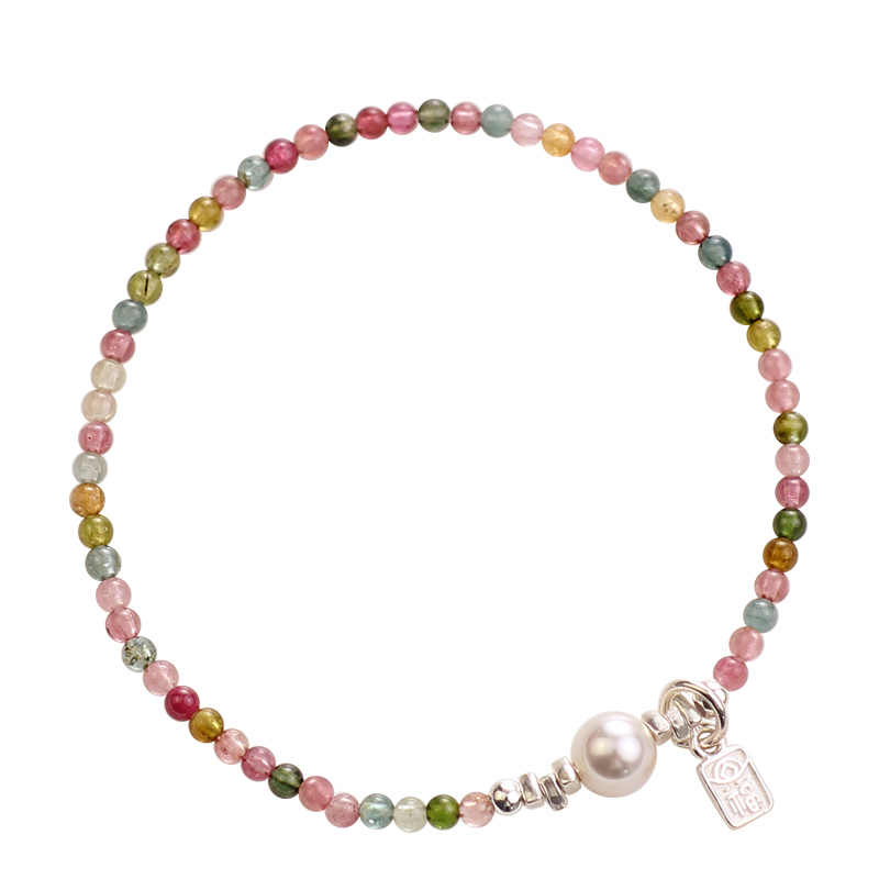 Multicolored beaded bracelet with a pearl charm on a white background