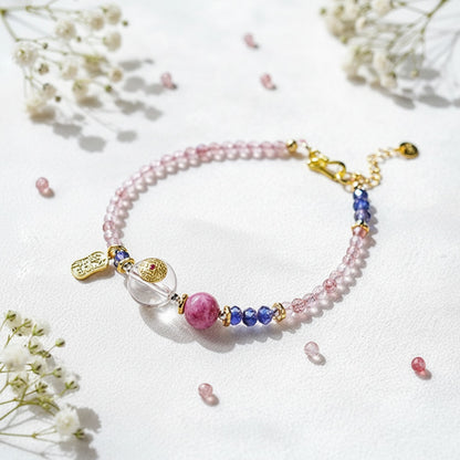 Colorful beaded bracelet with charms on a white background with flowers