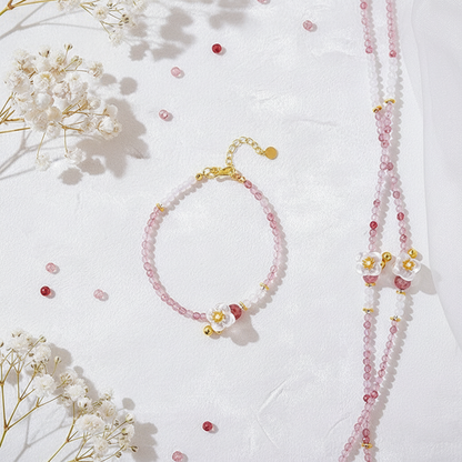 Beaded bracelet and necklace set with flowers on a white background