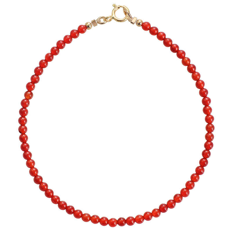 Red beaded necklace on a white background