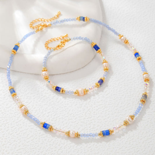 Necklace with blue, gold, and white beads on a white background