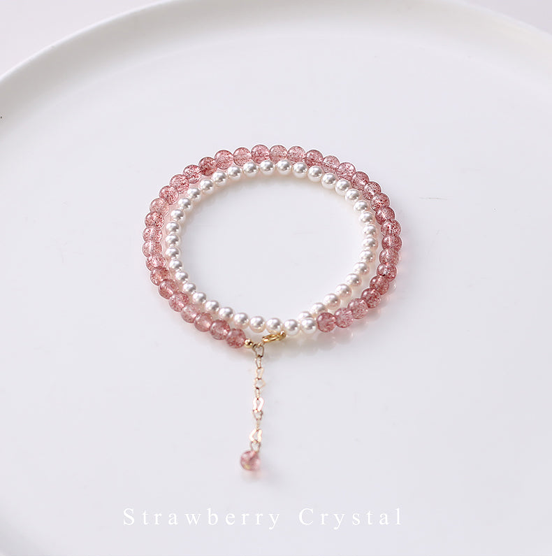 Bracelet with pink and white beads on a white background