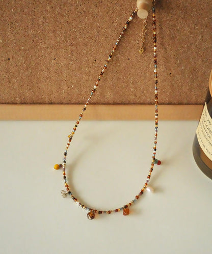 Beaded necklace on a corkboard background
