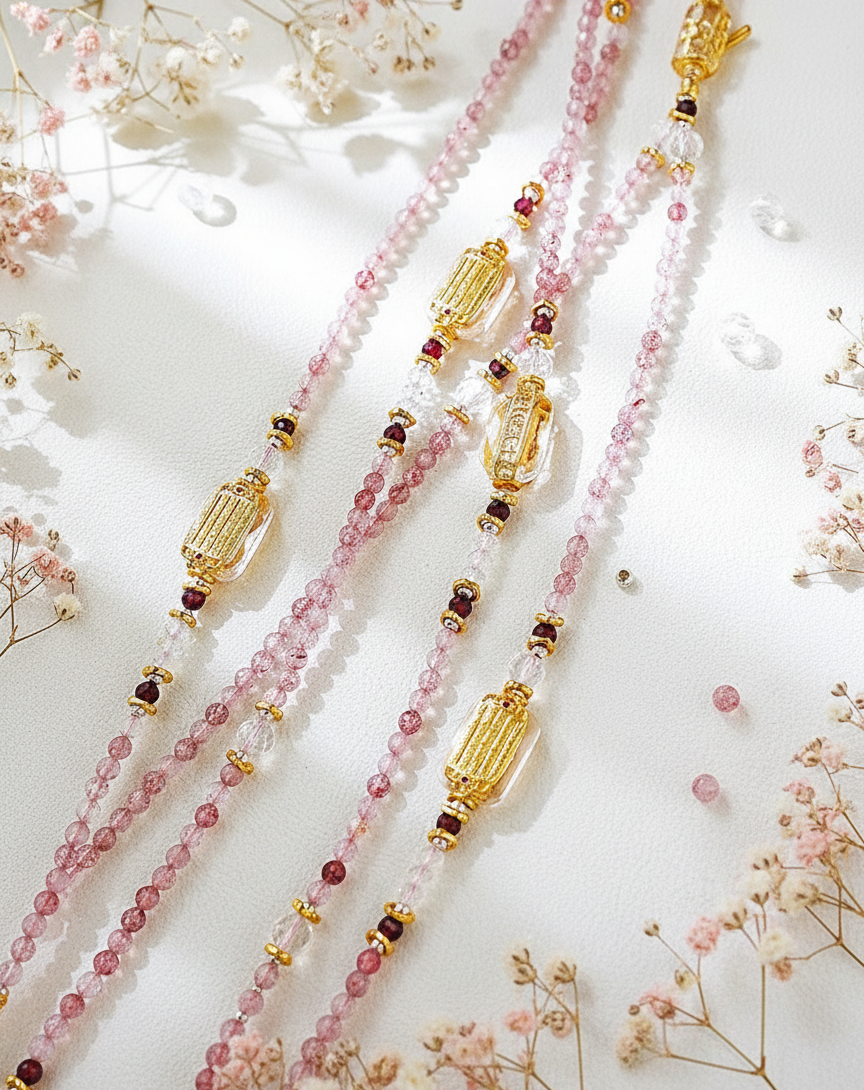 Beaded necklace with gold accents on a light background with flowers