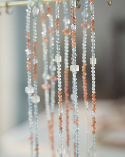 Close-up of beaded curtains with a blurred background