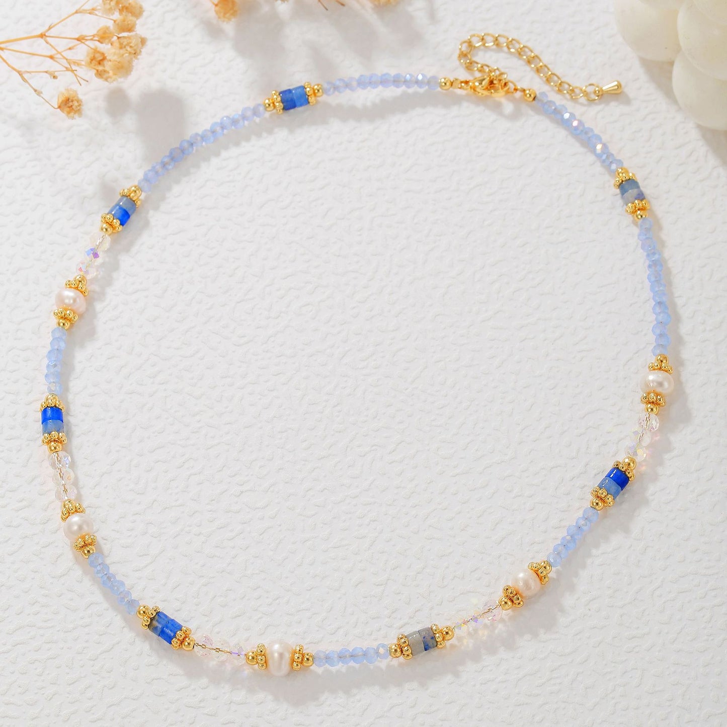 Necklace with blue and gold beads on a white background