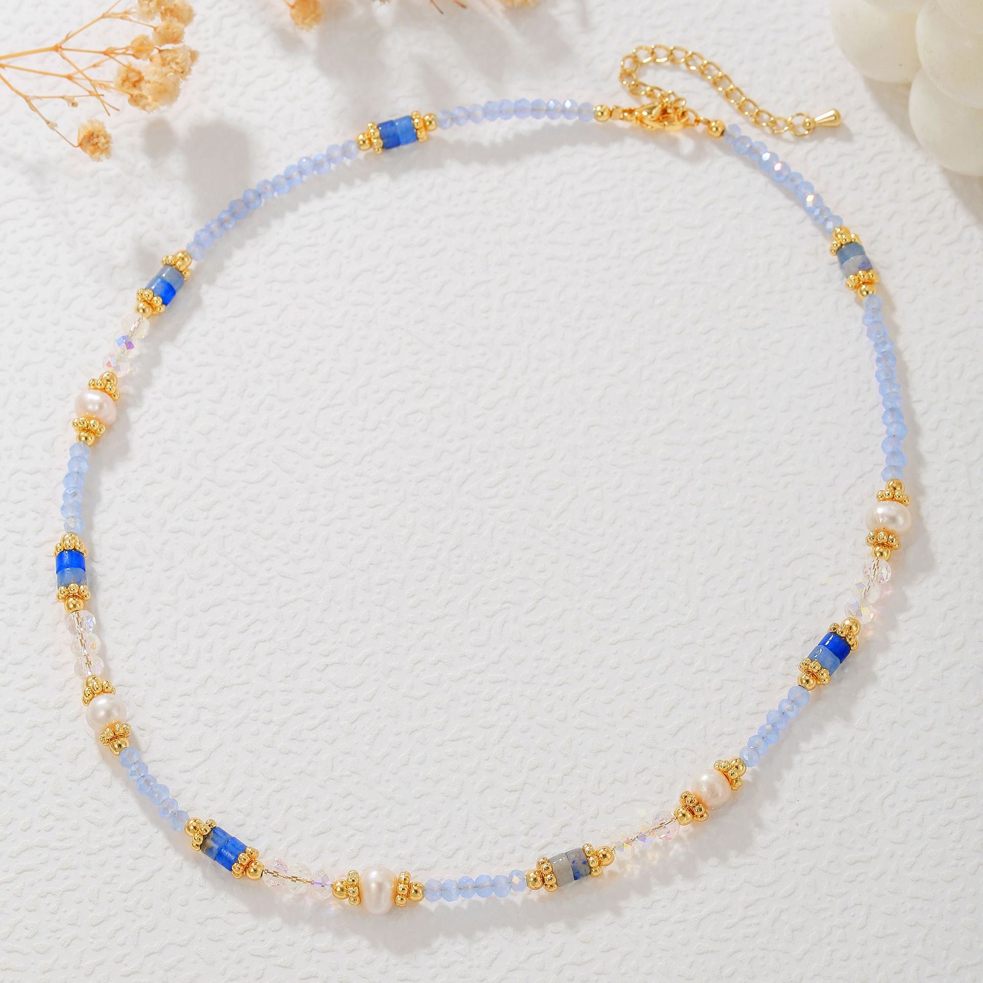 Necklace with blue and gold beads on a white background