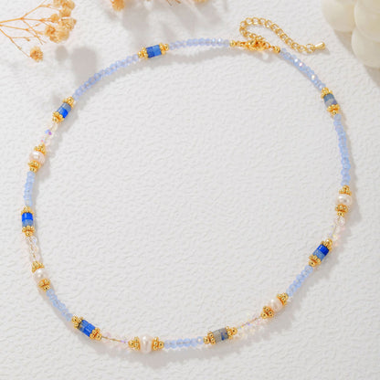 Necklace with blue and gold beads on a white background