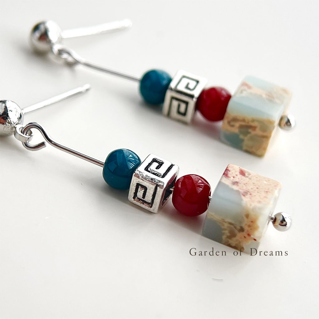 Beaded earrings with colorful beads on a white background, labeled 'Garden of Dreams'.