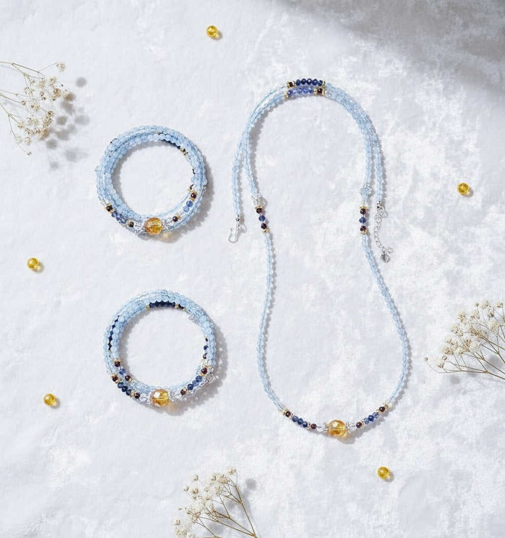 Beaded necklace and bracelets on a light background with small flowers
