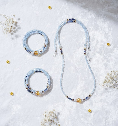 Beaded necklace and bracelets on a light background with small flowers