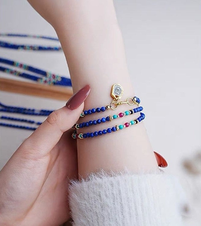 Multicolored beaded bracelet on a wrist with a blurred background
