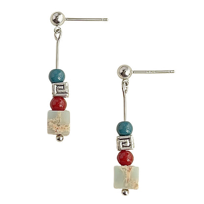 Pair of earrings with colorful beads on a white background