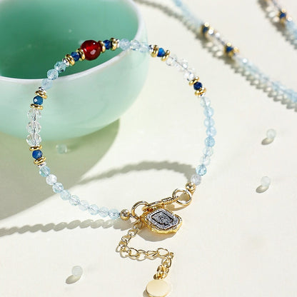 Beaded bracelet with gold charm on a light surface