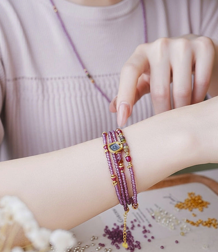 Person wearing a colorful bracelet on a neutral background