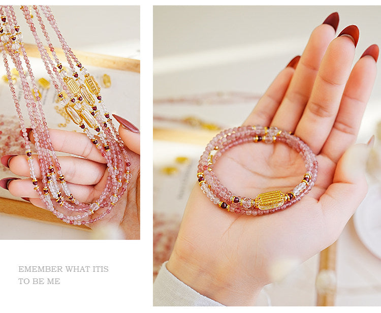 Close-up of a hand wearing a beaded bracelet with pink and gold beads.