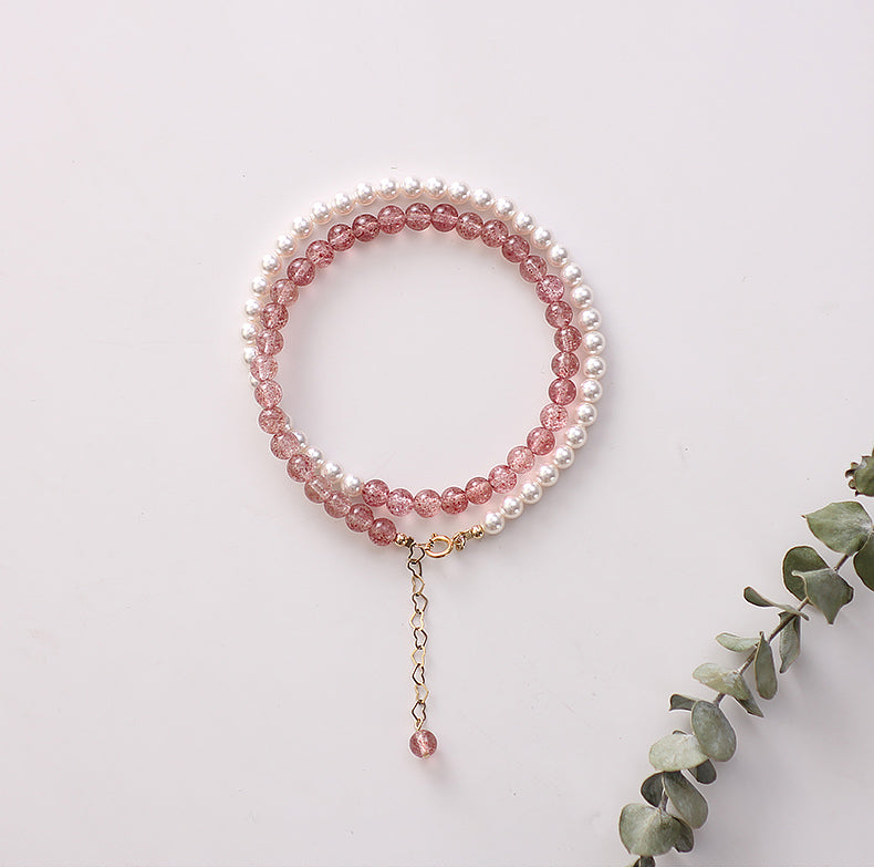 Beaded bracelet with pink and white beads on a light background.