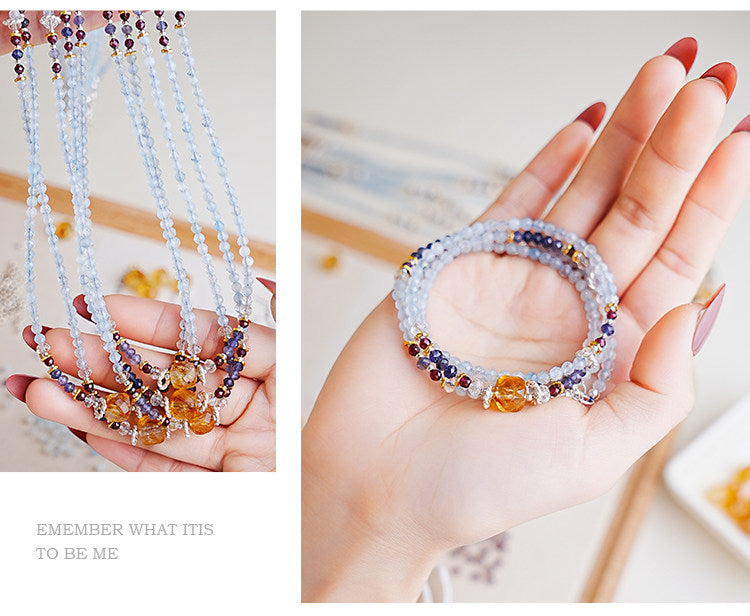 Multicolored beaded bracelets on a hand with a blurred background
